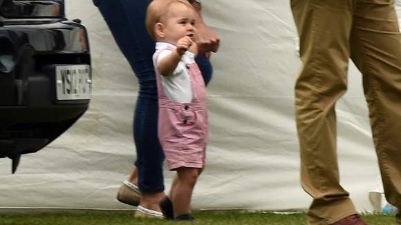 His hand firmly held by his mother, George appears a confident toddler.