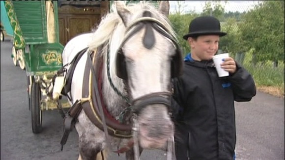 Young boy rests with his horse