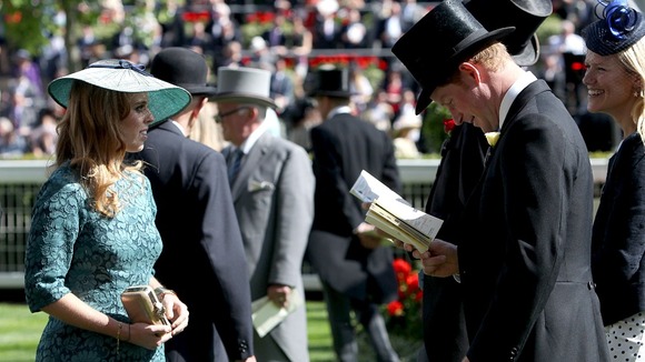 Prince Harry studies his race card, next to his cousin Princess Beatrice.
