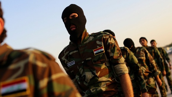 Mehdi Army fighters loyal to Sh'ite cleric Moqtada al-Sadr march in Najaf.