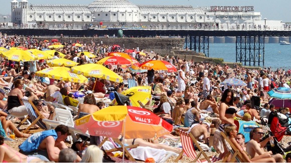 Crowded beach with pier