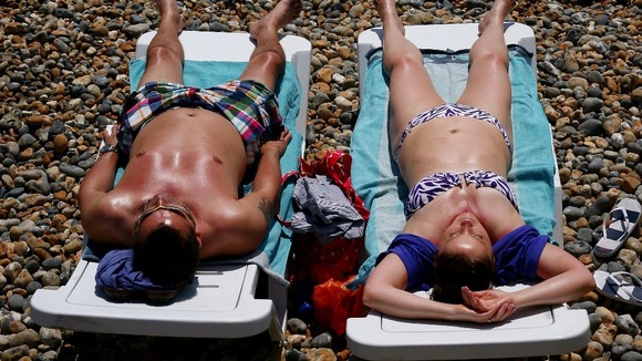 Sunbathers relax on Brighton beach.