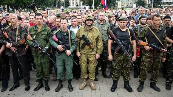 Armed pro-Russian separatists pledge an oath during a ceremony in the city of Donetsk today.