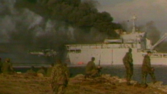 Soldiers on land and Sir Galahad on fire in distance
