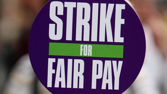 A council worker holds a Unison placard during a rally.
