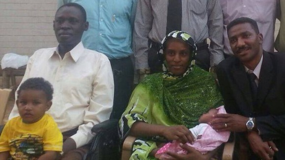 Meriam Ibrahim, centre, with her husband, left, and new-born baby by her side.