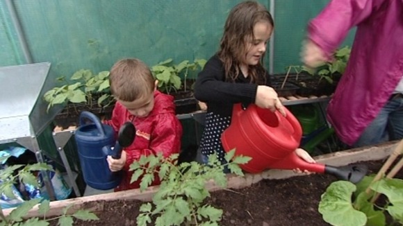 Children watering plants