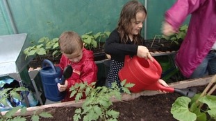 Children watering plants
