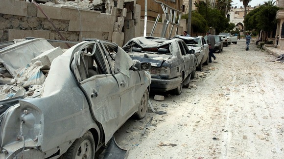 Damaged cars at the site where two bombs detonated near state buildings in Idlib last month