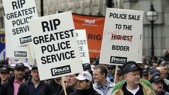 Police Federation members march during a protest against wide-ranging changes to their pay and pensions, at Millbank, London in May 2012