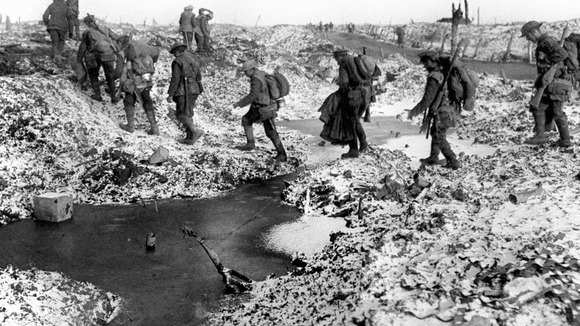 British soldiers negotiating a shell-cratered, Winter landscape along the River Somme in late 1916 after the close of the Allied offensive.