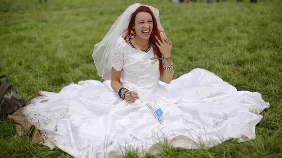 Festival goer and newly-wed Hannah Lomas, aged 27, from Liverpool, wore her wedding dress to the event in Somerset.