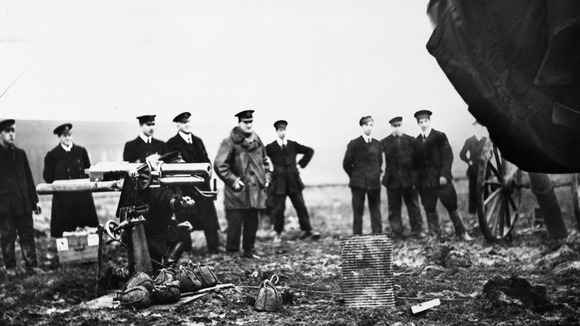 Soldiers experiment with carrying guns on airships in this photograph dated circa 1915.