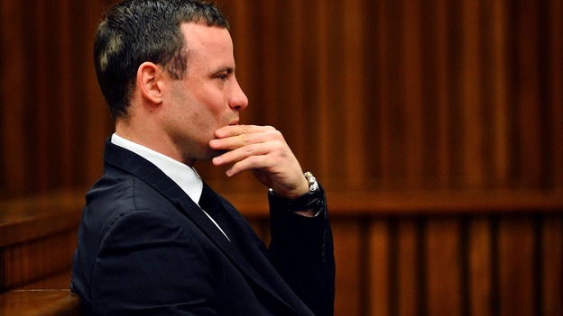 Oscar Pistorius listens to his doctor give evidence at his murder trial.