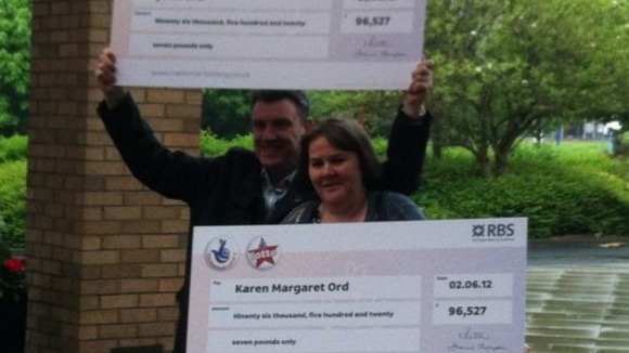 John and Karen Ord with their identical cheques