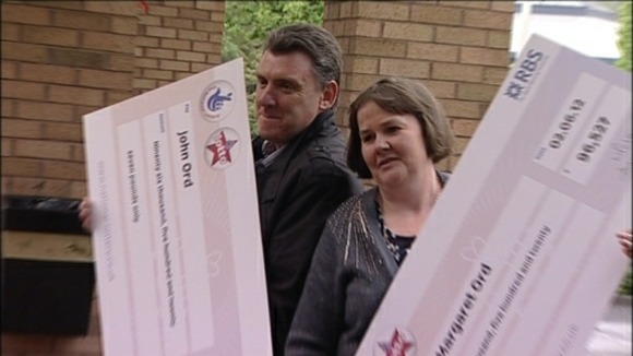 The winners with their cheques