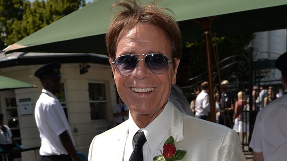 Praying for rain? Sir Cliff Richard observed the formal dress code requirements at Wimbledon.