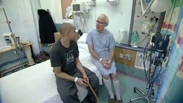 Louis and Mike Powis on hospital bed