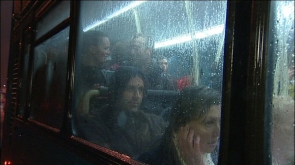 Soaked fans on the bus