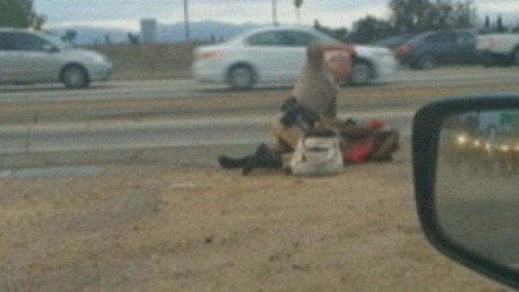 The Los Angeles police officer was filmed knocking the woman to the ground before repeatedly punching her.