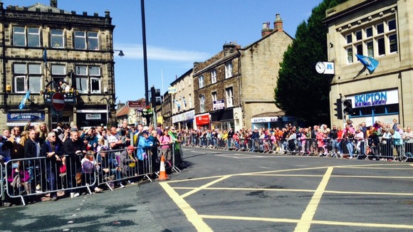 Crowds gather in Otley, one of the Yorkshire towns on the route.