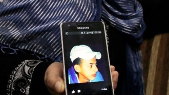 Suha, mother of murdered Palestinian teen Mohammed Abu Khudair, shows a picture of her son.