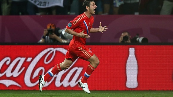 Alan Dzagoev enjoys scoring Russia's first.