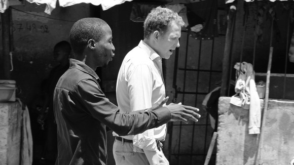Ebola survivor Dr Bakary Oularé with ITV News correspondent Dan Rivers in Conakry.