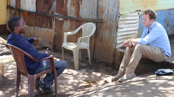 Ebola survivor Dr Bakary Oularé with ITV News correspondent Dan Rivers in Conakry.