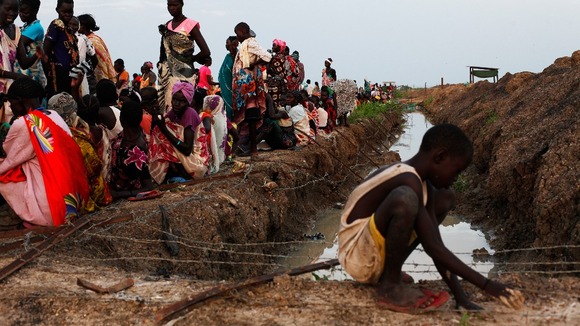 Women and children wait for food at a refugee camp in South Sudan.