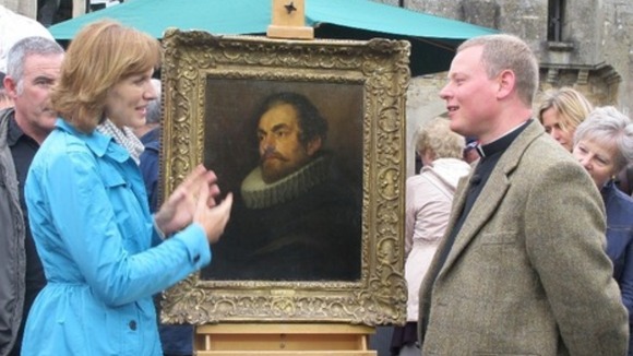 Father Jamie MacLeod with the van Dyck, portrait bought for £400, with Antiques Roadshow host Fiona Bruce.