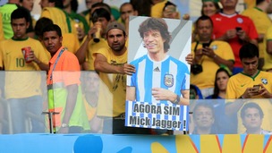A fan holds a placard with Jagger in an Argentina shirt.