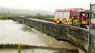The A487 into Machynlleth in Powys, Wales is blocked by the fire service due to safety concerns caused by fast flowing flood water.