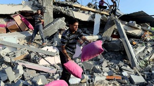 Palestinians collect their belongings from the rubble in Rafah in the southern Gaza Strip.