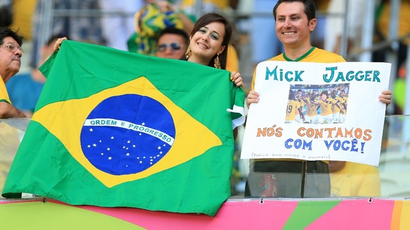 Brazil fans smile before the World Cup semi-final in which they lost 7-1 to Germany,