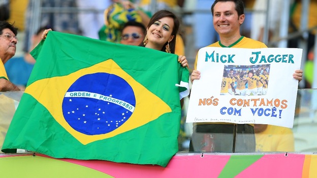 Brazil fans smile before the World Cup semi-final in which they lost 7-1 to Germany,
