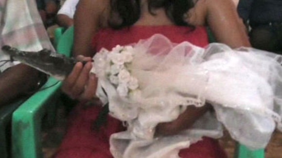 The 'princess' crocodile bride wore a traditional white dress for the ceremony.