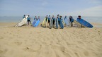 kids with surfboards on the beach