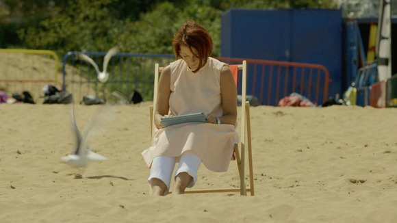 lady on deck chair on beach