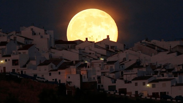 The "supermoon" rises over houses in Olvera, Spain.