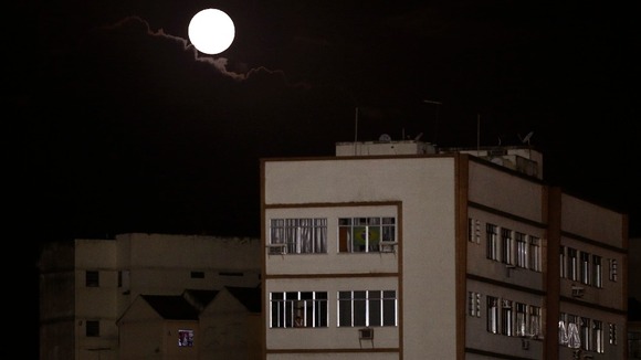 A moon is seen over the neighbourhood of Vasco da Gama in Brazil.