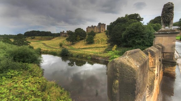 Alnwick Castle and moat plus moody overcast sky