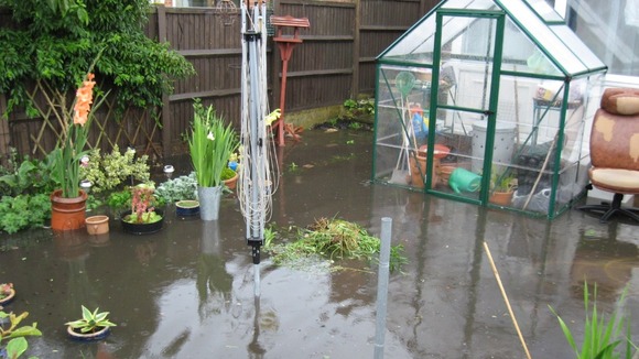 Flooded garden in Gorleston, Norfolk after the downpours on Sunday 13 July