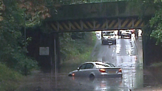 A car trapped in flooding below a railway bridge near Brundall, Norfolk.