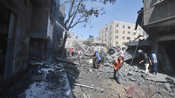 Palestinians extinguish a fire which police said was caused by an Israeli air strike in Rafah in the southern Gaza Strip.
