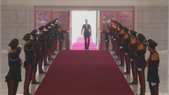 Syrian president Bashar al-Assad walks down a red carpet as he is sworn in for a new term.