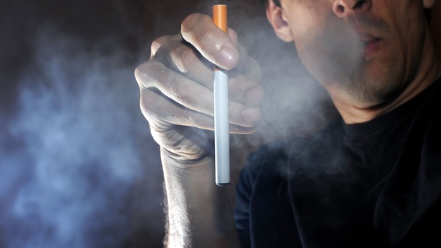 A man uses an electronic cigarette.