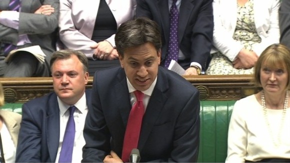 Ed Miliband speaks as Ed Balls looks on.