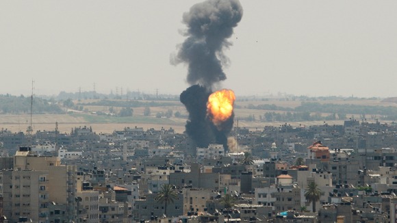 Smoke and flames are seen following what witnesses said was an Israeli air strike in Gaza City