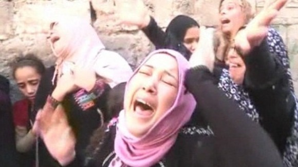 Women stricken with grief at the funeral.